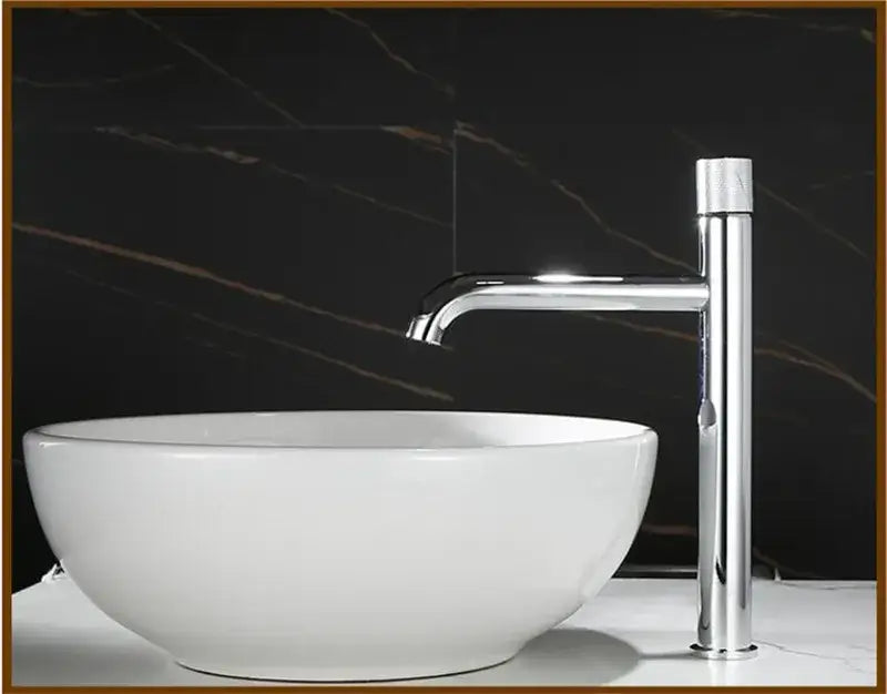 Chrome finished modern single handle basin faucet with sleek tall design and polished metallic finish for bathroom use