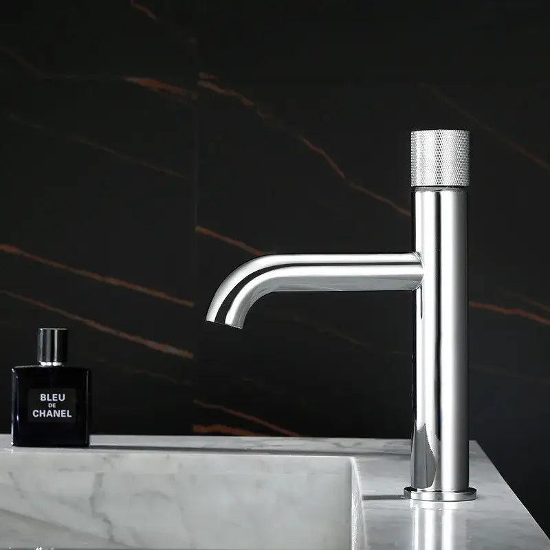 Modern brushed gold single handle basin faucet with knurled textured handle and sleek minimalist design