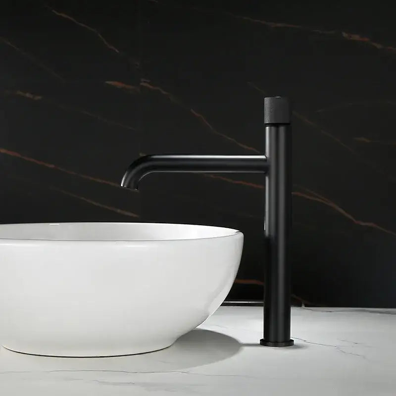 Black matte basin faucet with sleek minimalist design paired with modern brushed gold single handle mixer