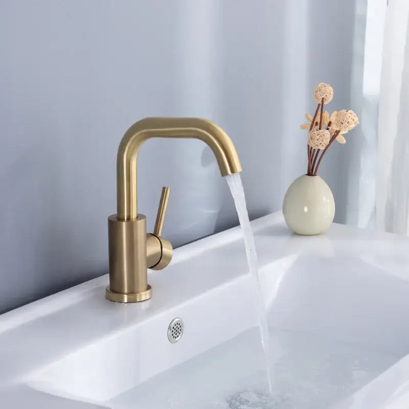 Modern brushed gold single handle basin faucet with a sleek curved spout for bathroom mixer tap use