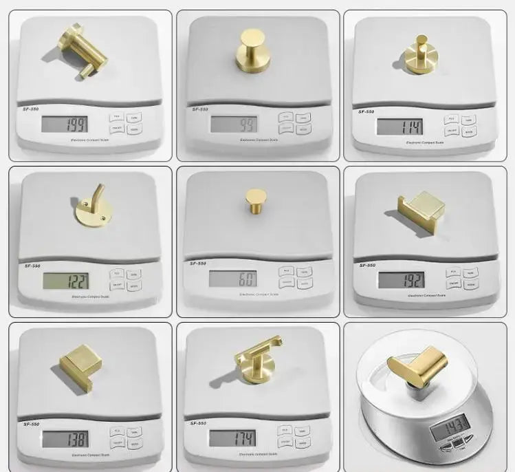 Modern brushed gold stainless steel robe hook with various gold-colored brass hardware pieces for cabinetry and furniture