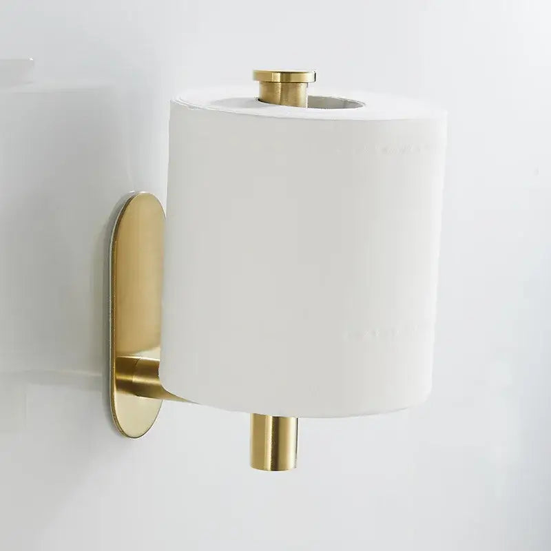 Gold-toned brushed gold stainless steel tissue holder wall mounted with modern design holding white toilet paper roll