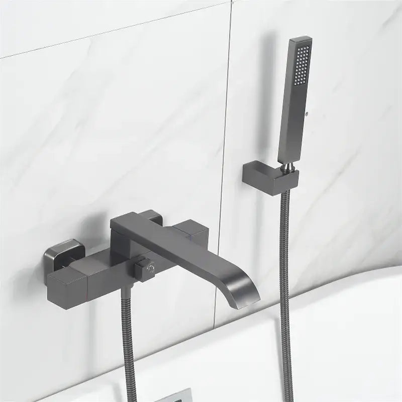 Modern matte black bathtub faucet with matching handheld contrasts with decorbites brushed gold wall mounted set