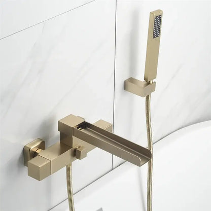 Modern brushed gold wall mounted waterfall bathtub set with sleek angular gold wall mounted faucet and handheld showerhead