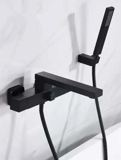 Black matte modern bathroom faucet with integrated handheld showerhead complementing decorbites brushed gold wall decor