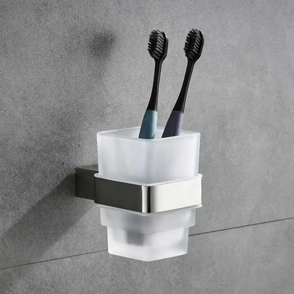 Modern frosted glass toothbrush holder with sleek brushed nickel bracket holding two black-bristled toothbrushes in bathroom hardware set