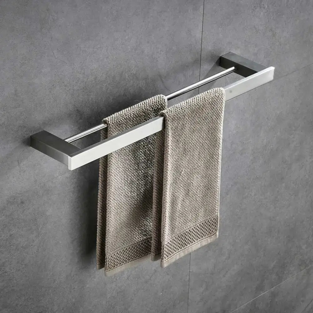 Modern brushed nickel bathroom hardware set with glass accents featuring a brushed stainless steel double towel rack with beige towels