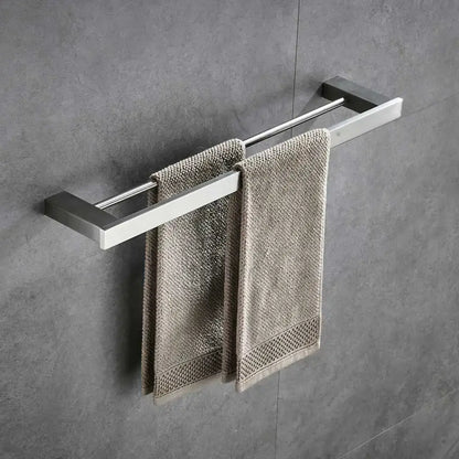 Modern brushed nickel bathroom hardware set with glass accents featuring a brushed stainless steel double towel rack with beige towels