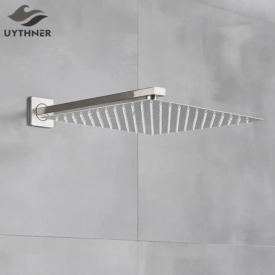 Modern brushed nickel stainless steel square rainfall shower head with sleek design and evenly spaced nozzles for rainfall shower