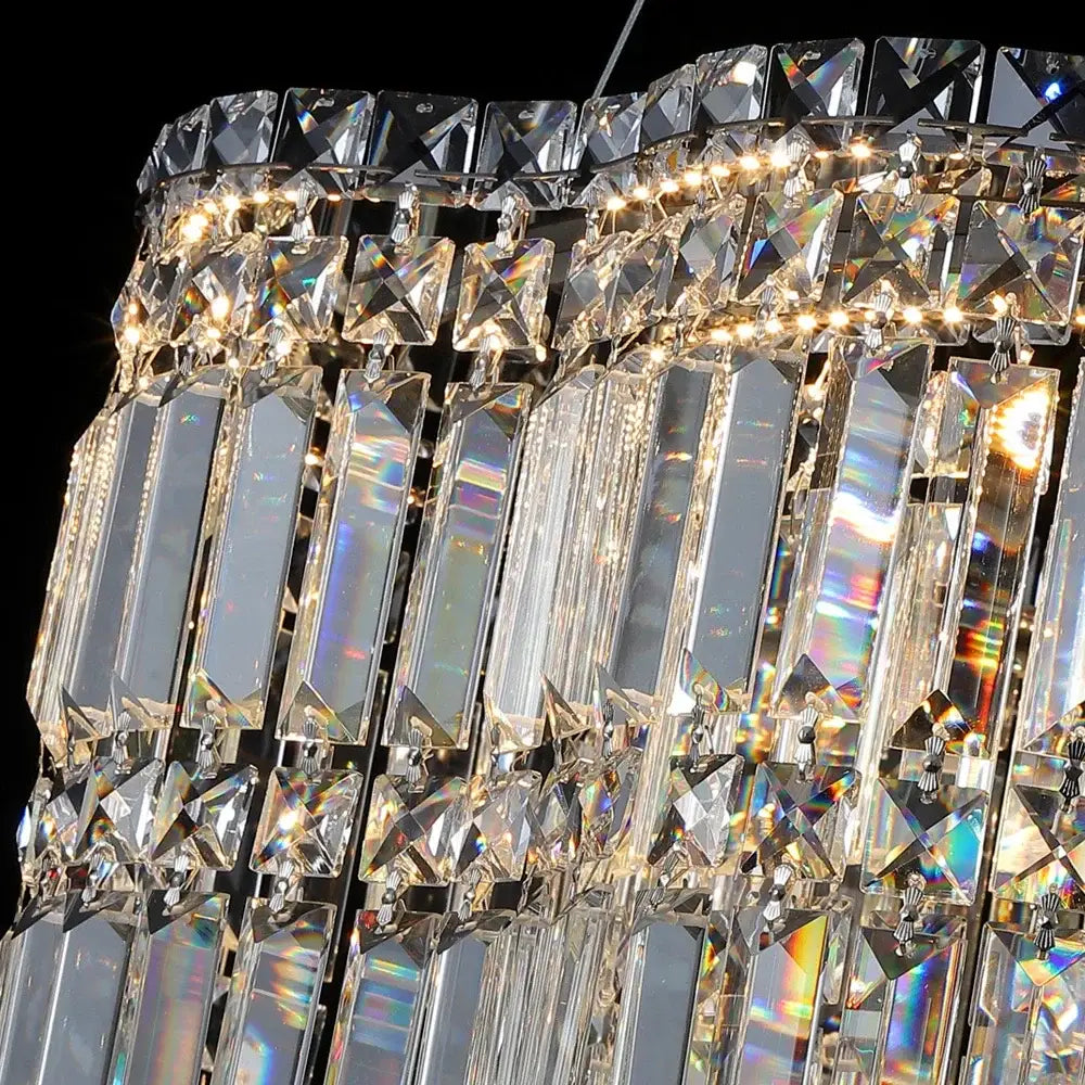 Modern brushed stainless crystal pendant light chandelier with multi-tiered faceted crystals and warm illumination