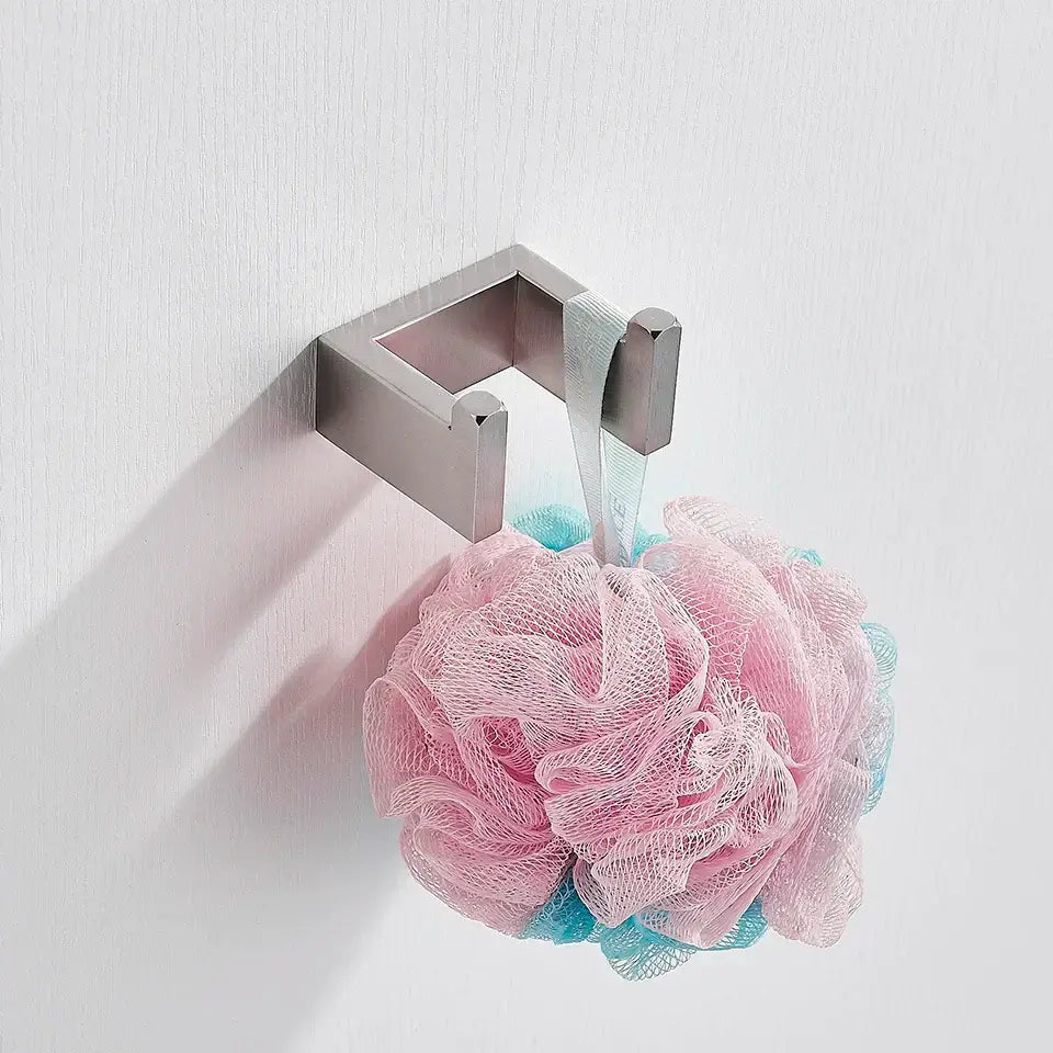 Modern brushed stainless steel bath hardware set with silver hook holding pink and blue mesh loofah for bathroom use