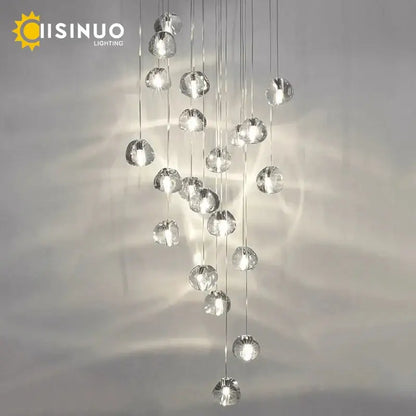 Modern brushed stainless steel pendant light featuring a clear crystal globe with a cascading design for staircases