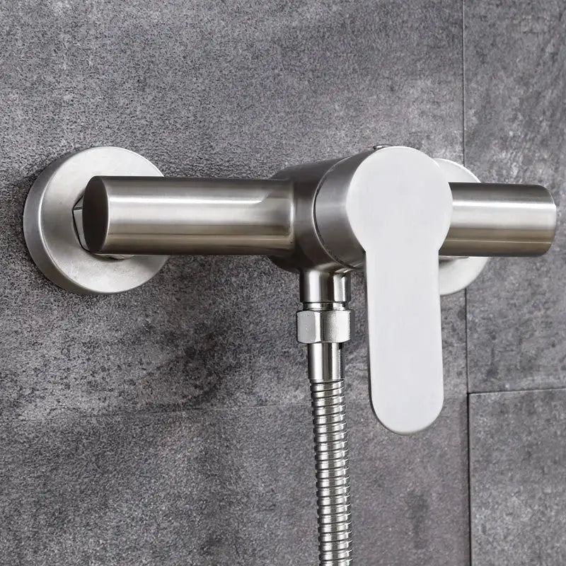 Modern brushed stainless steel and white ceramic shower mixer with flexible hose for bathroom use