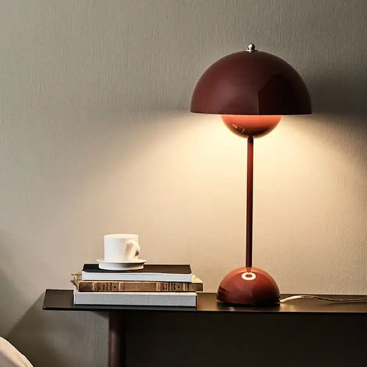 A sleek burgundy decorbites iron mushroom shape table lamp with a flower-like design and smooth metallic finish