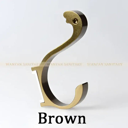 Brown brass-colored hook with curved ornate design in decorbites candy color aluminum finish for kitchen organizer