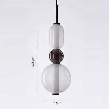 Modern candy glass ceiling chandelier with three stacked translucent white and dark brown glass orbs on black rod
