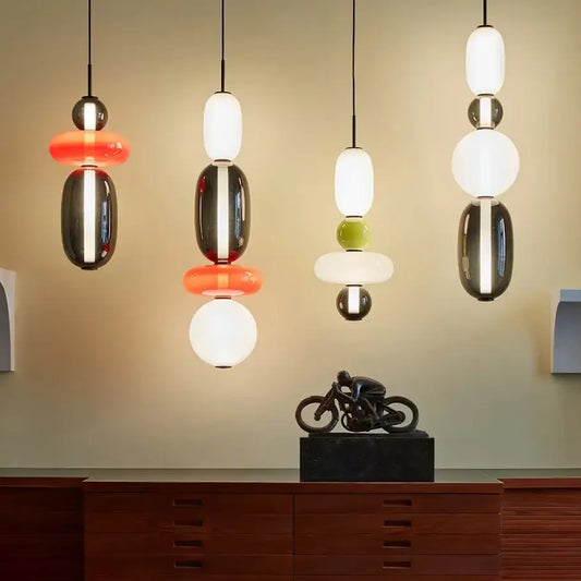 Modern candy glass ceiling chandelier with stacked glossy glass and metallic spheres in black white orange and green hues