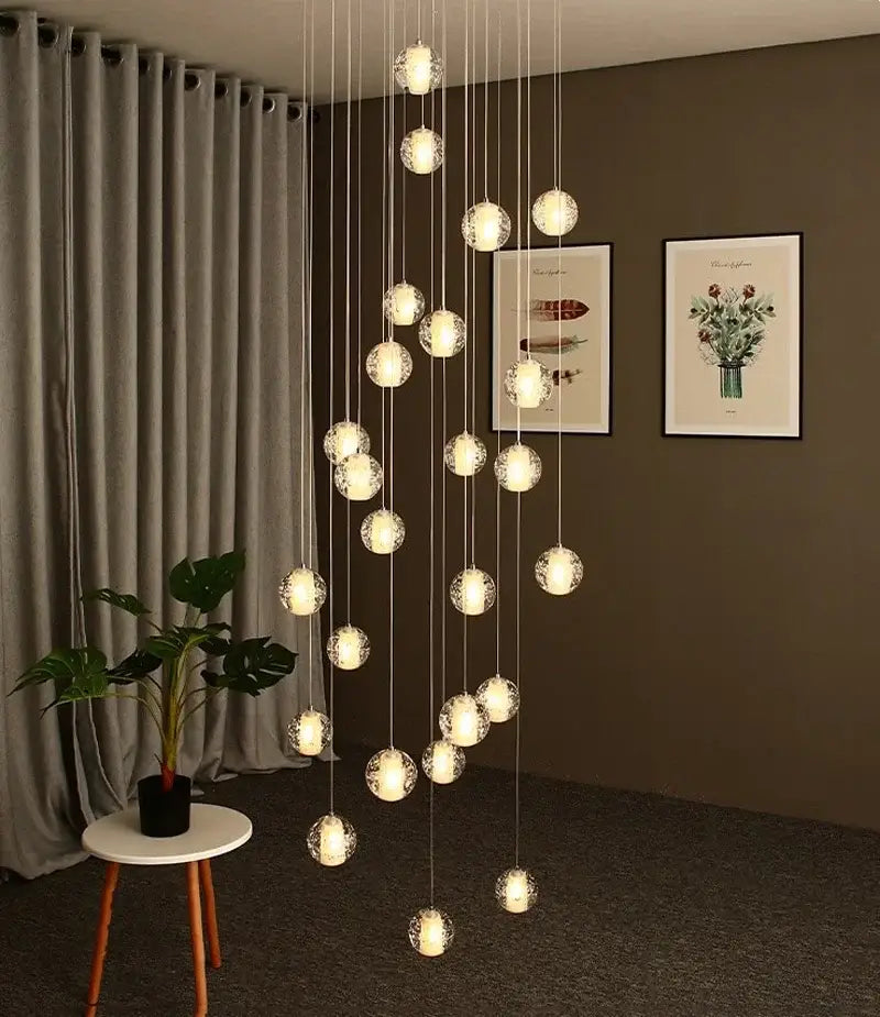 Modern cascading crystal ball led pendant light with frosted glass globes and thin metallic cords for living room decorbites pendant light