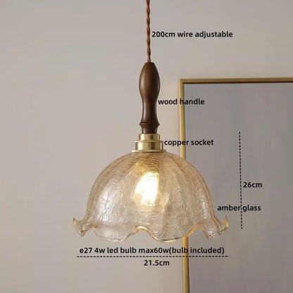 A warm amber decorbites ceramic led pendant light with crackled finish and wooden handle for dining room decor