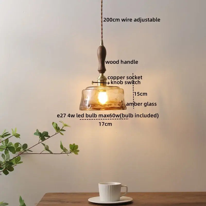 A warm amber glass ceramic led pendant light with wooden handle and copper socket for modern dining decorbites ceramic led