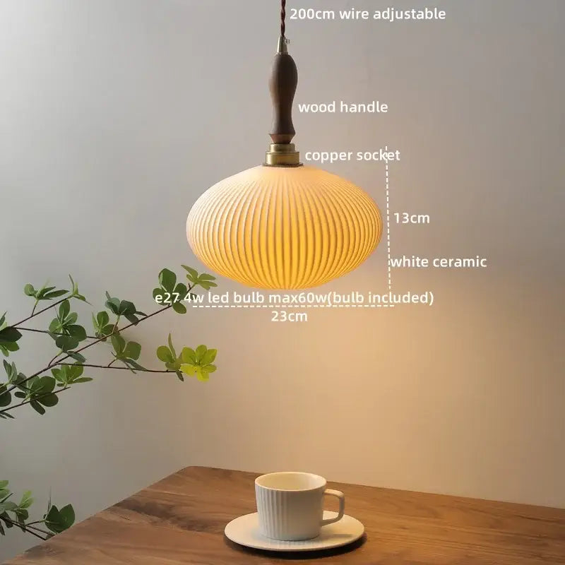 A warm off-white decorbites ceramic led pendant light with vertical ridges and wooden handle for dining room decor
