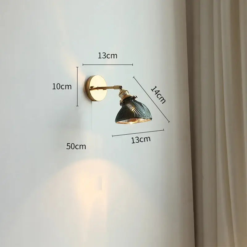 Brass-finished industrial-style wall light with green ribbed glass led shade and adjustable arm for bedroom use