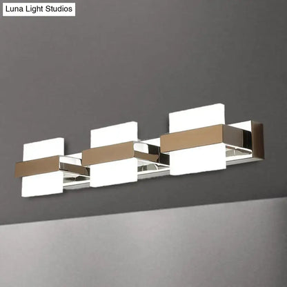 Modern chrome three-light vanity wall light with sleek chrome and brushed gold acrylic panels for bathroom use