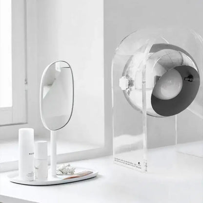 Modern chrome acrylic led desk lamp beside a minimalist white oval vanity mirror for bedroom decorbites acrylic led setup