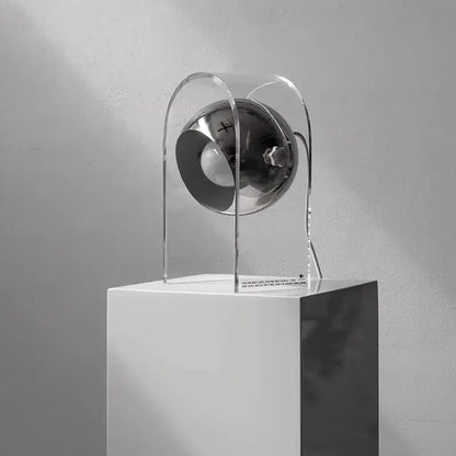 A modern chrome acrylic led desk lamp with a sleek spherical design and transparent acrylic frame for bedroom use