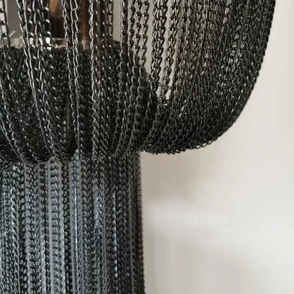 Black aluminum chain sconce with cascading textured curtain design for modern bedroom wall lighting