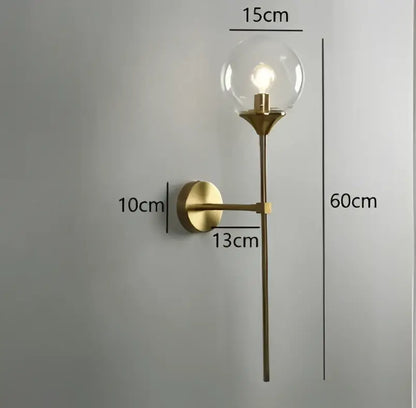 Modern chrome and amber glass ball wall lamp featuring brass-finished wall sconce with clear glass ball bulb for decorbites lighting