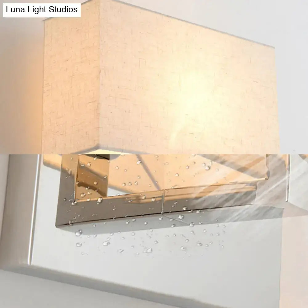 Modern chrome and beige fabric shade wall light with polished metal base and fabric shade width for bedroom use
