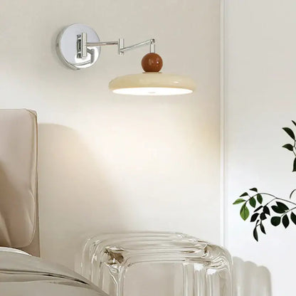 Modern chrome and ceramic iron wall light with adjustable polished chrome arm and warm ceramic sphere shade for bedroom decor