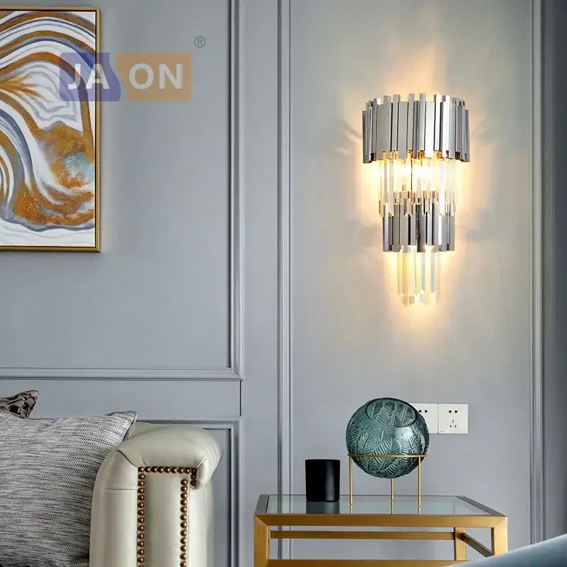Modern chrome and gold decorbites crystal clear led wall sconce with cascading crystal rods emitting warm glow for bedroom