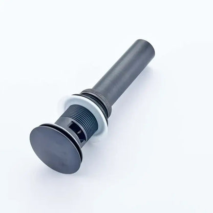 Modern chrome and gold bathroom sink pop up drain stopper with black matte finish and white rubber gasket visible from back side