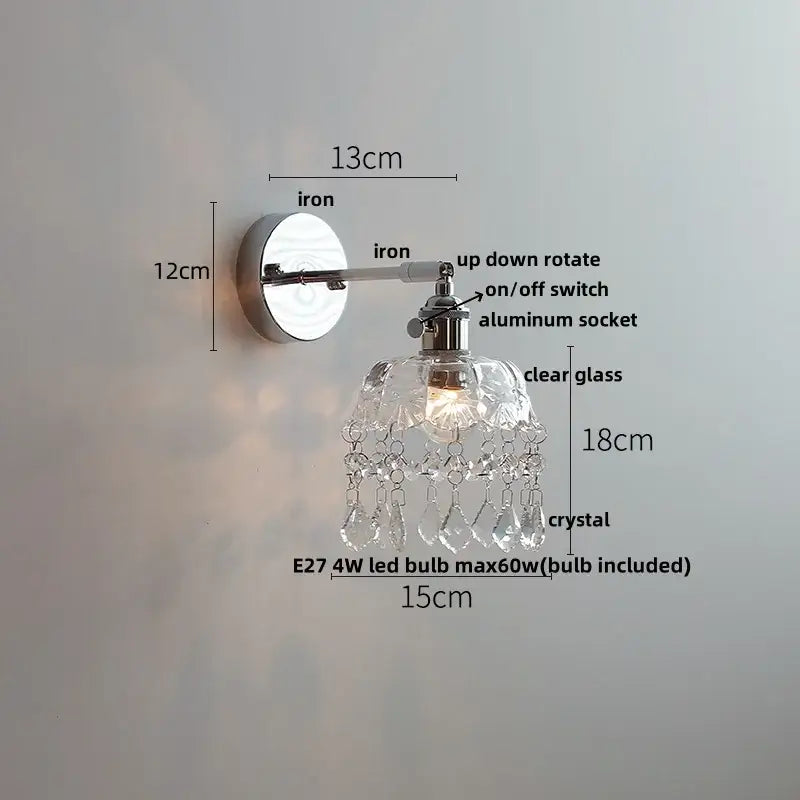 Modern chrome wall light fixture with clear glass shade and dangling crystal droplets for bedroom use