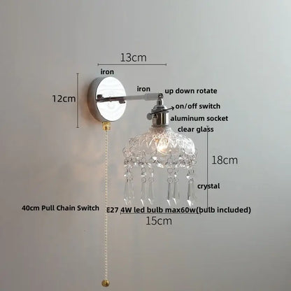 Modern chrome wall light fixture with polished iron base, aluminum socket, clear glass shade, and crystal droplets