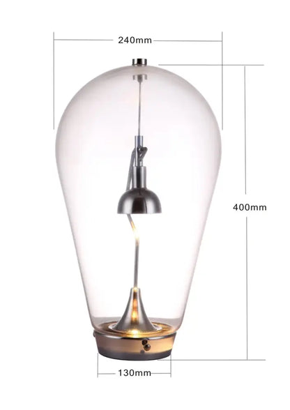 A modern chrome and transparent lodes blow glass table lamp with teardrop design for elegant living room decorbites lodes blow