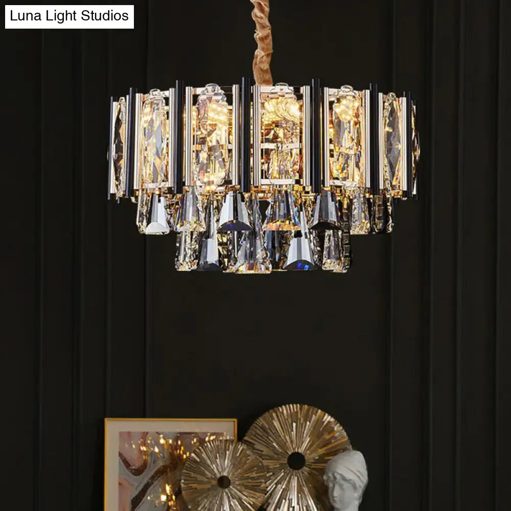 A modern DecorBites clear beveled crystal chandelier with gold prisms and black metal frame featuring adjustable chain cord length