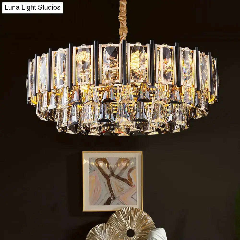 Gold-toned decorbites chandelier with faceted crystal panels and teardrop crystals chain cord length adjustable