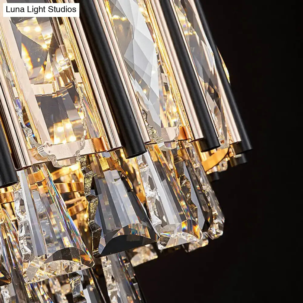 A modern DecorBites clear beveled crystal chandelier with black rods gold fittings and adjustable chain cord length