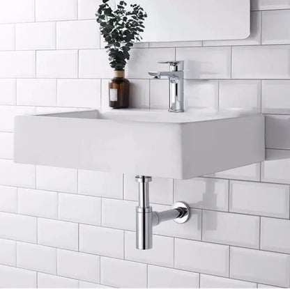 Modern white wall-mounted sink with a sleek chrome decorbites brass round bottle trap and matching drain pipe