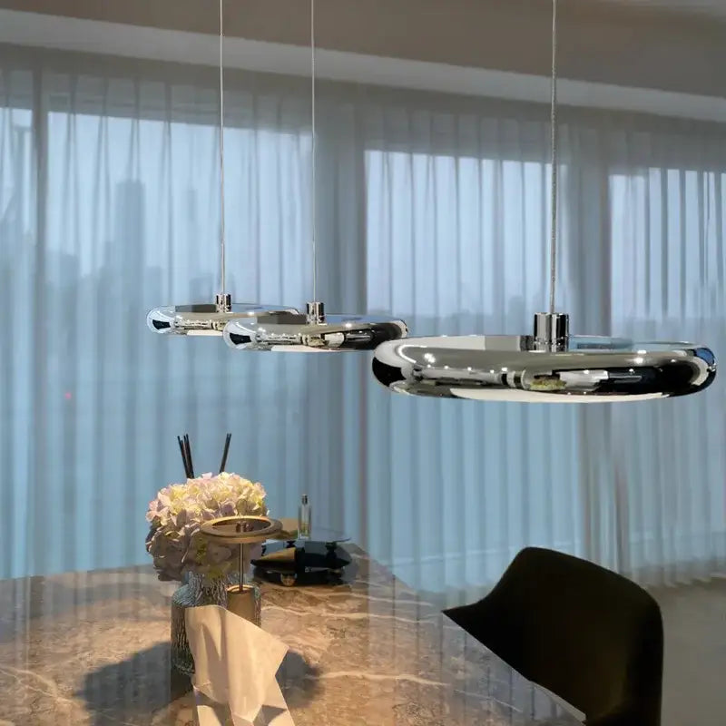 Modern chrome circular dining pendant led light with sleek elongated oval shapes for decorbites circular dining use