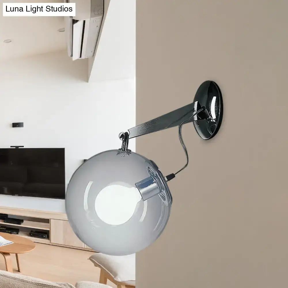Modern chrome clear glass bubble wall sconce featuring a frosted glass bubble and chrome-finished arm for bedroom use