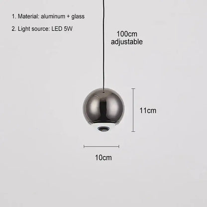 A sleek modern chrome ball pendant light with reflective finish and glass construction for dining room lighting