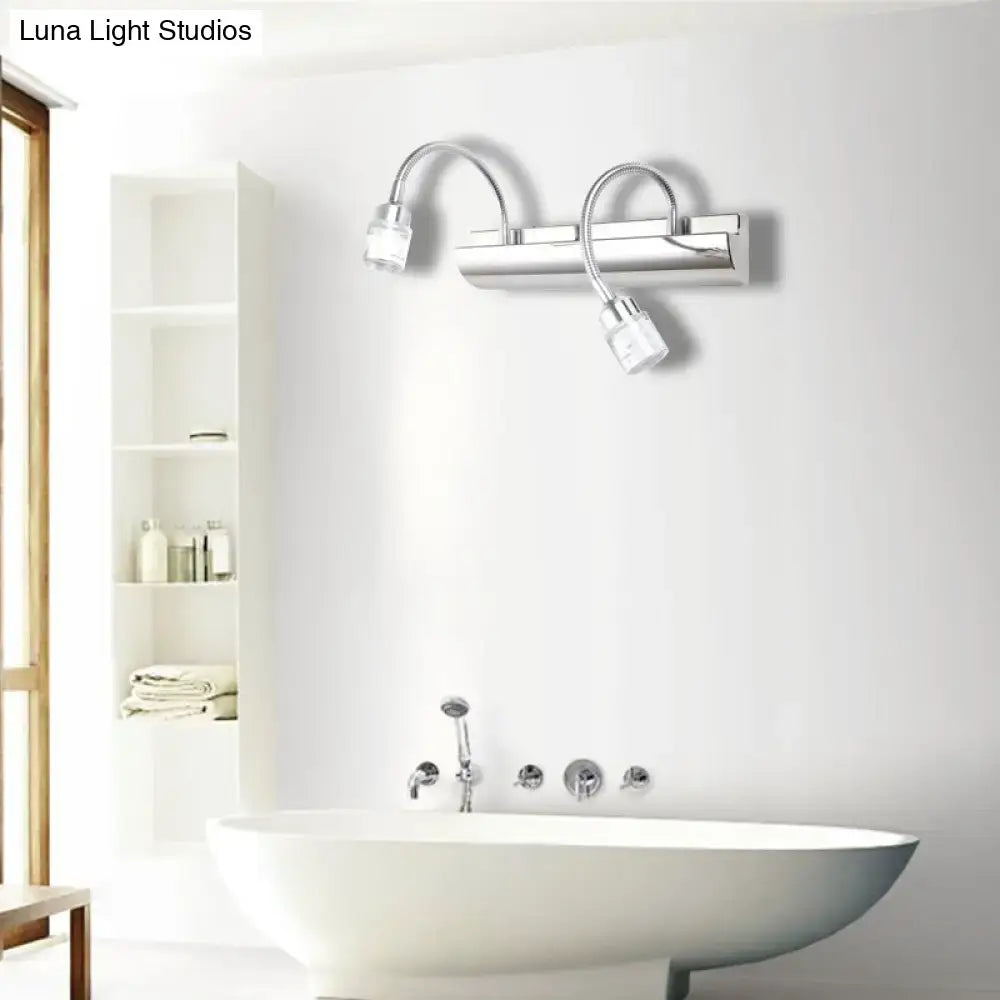 Modern chrome crystal cylinder wall sconce with two flexible gooseneck arms and clear crystal cylinder shades for bedroom reading