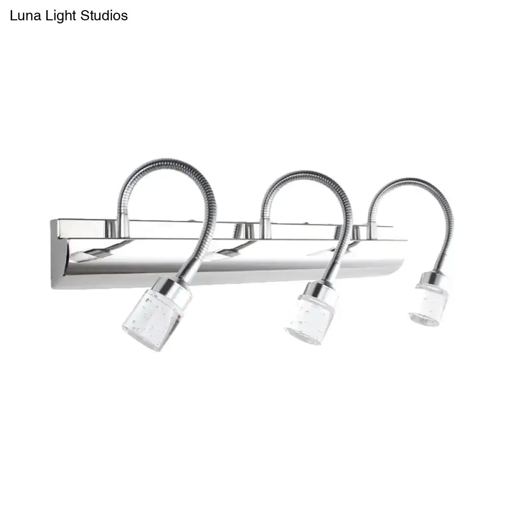 Modern chrome crystal cylinder vanity wall sconce with three clear crystal cylinder shades and flexible gooseneck arms