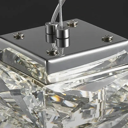 A modern chrome crystal dining table pendant lamp with faceted clear glass elements and sleek metal base for kitchen island decorbites crystal dining