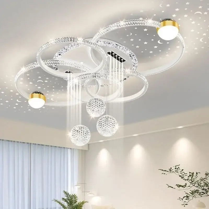 Modern chrome led pendant chandelier with interlocking crystal rings and gold-toned accents for dining room lighting