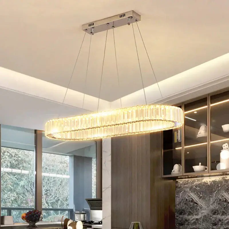 Modern chrome crystal oval led chandelier with cascading crystals emitting warm golden light for luxury living room decorbites crystal oval